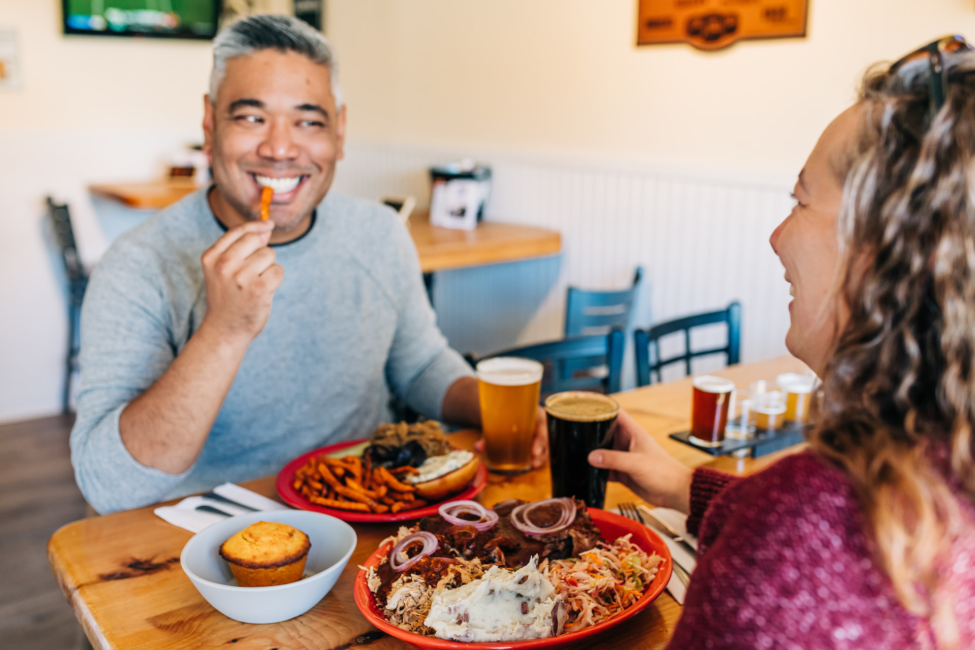 Diners enjoying smoked BBQ and craft beer at Moat Mountain Smokehouse and Brewing Company in North Conway, New Hampshire